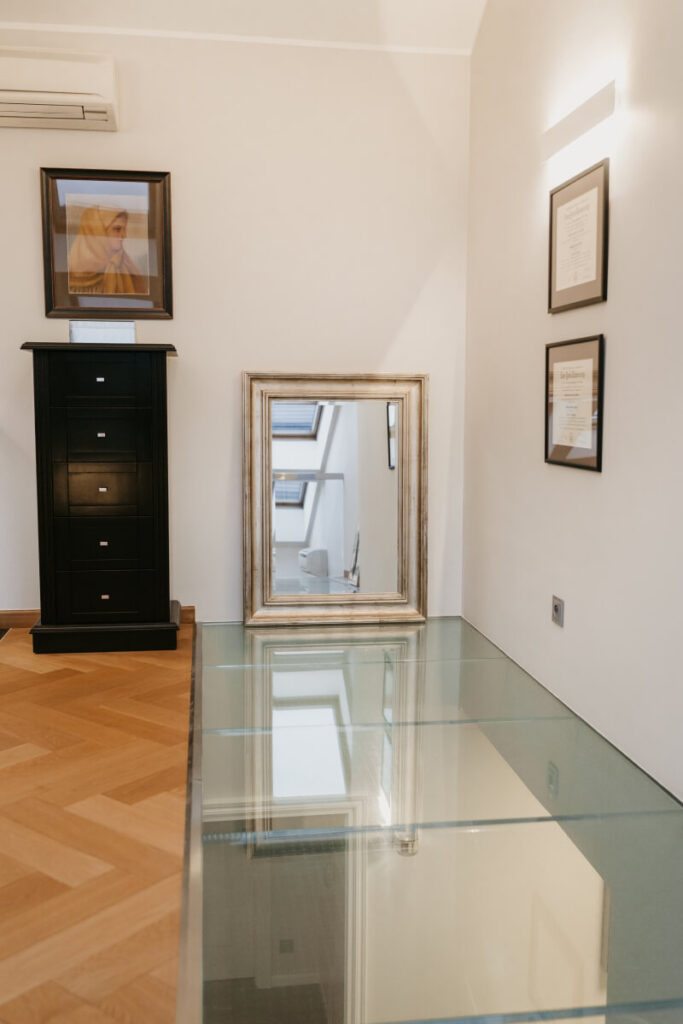 Stylish glass floor with a mirror on it showing through to the downstairs room below